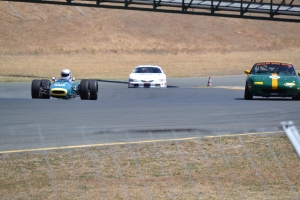 Three cars going up the hill at Sonoma Raceway