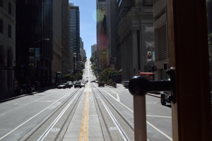 On the cable car heading up California street.  Took this while hanging off the side.